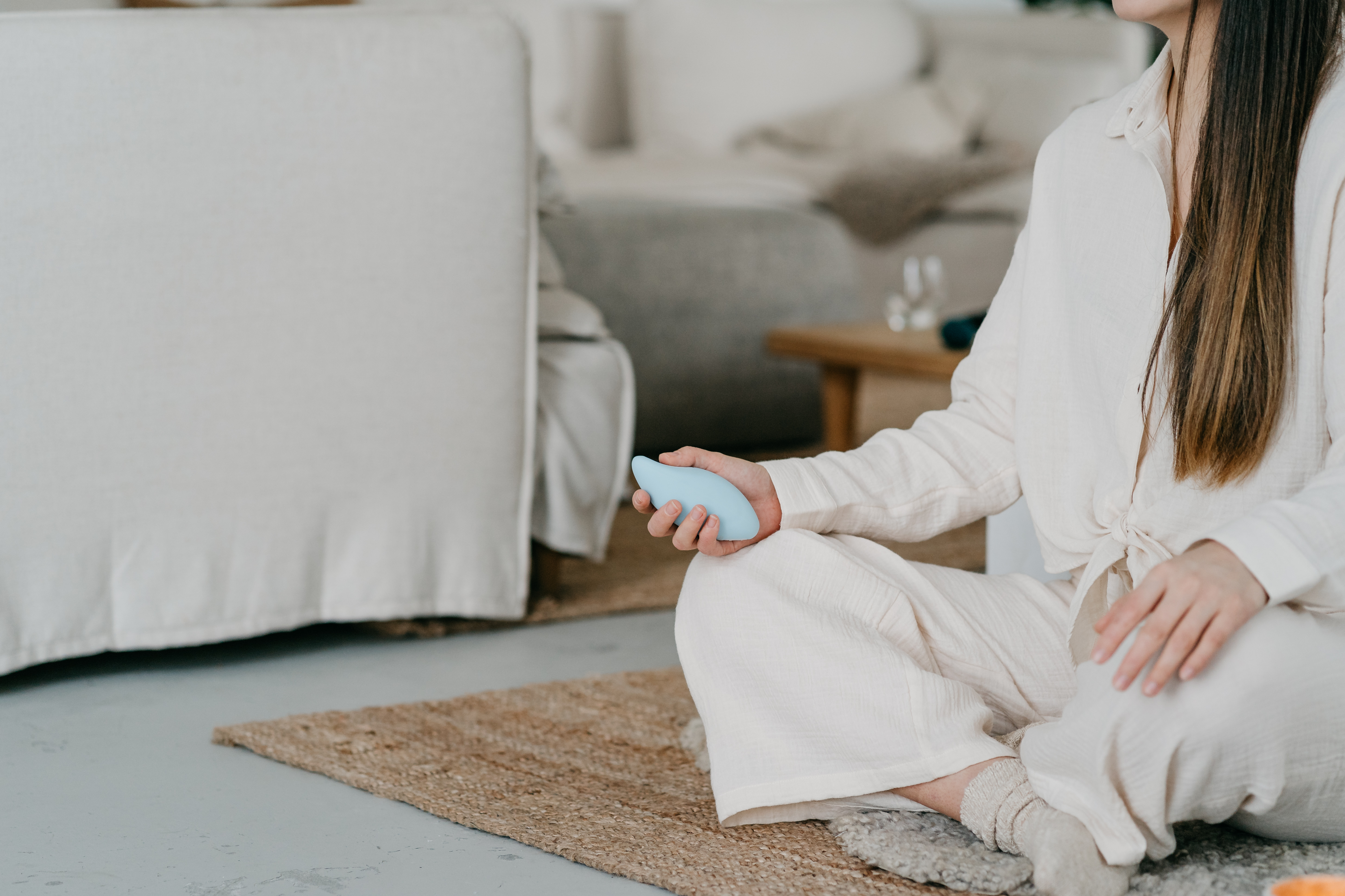 woman using the Moonbird handheld breathing device